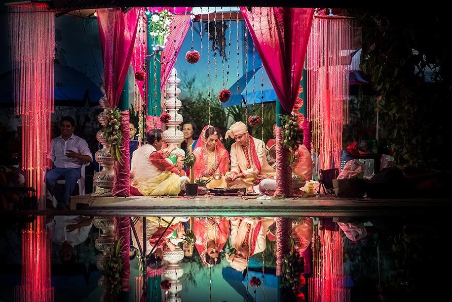 Wedding rituals beneath colourful drapes